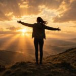 Confident woman standing tall on a hilltop at sunset with arms open wide, for self respect quotes